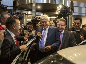 Mexico's President-elect Andres Manuel Lopez Obrador is surrounded by the press as he leaves a hotel where he gave a press conference in Mexico City, Monday, July 9, 2018. Lopez Obrador campaigned on a promise to return to Mexico's traditional foreign policy of nonintervention.