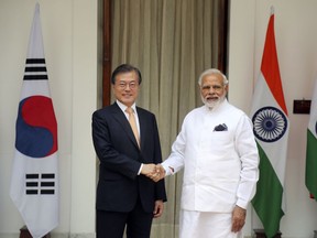 South Korean President Moon Jae-in, left, shakes hand with Indian Prime Minister Narendra Modi before their meeting in New Delhi, India, Tuesday, July 10, 2018. Moon is on a three- day visit to India.