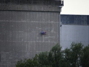 In this photo released by Greenpeace, a drone resembling the character Superman crashes into a wall of the nuclear power plant of Le Bugey, central, France, Tuesday, July 3, 2018. The environmental activist group says the drone was harmless but the action showed the lack of security in nuclear installations in France, which is heavily dependent on atomic power.