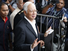 In this photo taken Thursday, May 24, 2018, former Malaysian Prime Minister Najib Razak, center, speaks to media as he leaves the Malaysian Anti-Corruption Commission (MACC) Office in Putrajaya in Kuala Lumpur.
