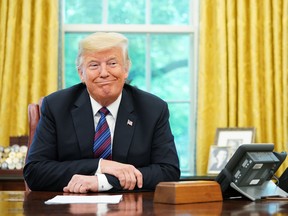 U.S. President Donald Trump listens during a phone conversation with Mexico's President Enrique Pena Nieto on trade in the Oval Office of the White House in Washington.