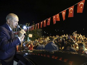 Turkey's President Recep Tayyip Erdogan addresses supporters at his Black Sea hometown, Guneysu, Turkey, early Friday, Aug. 10, 2018. Turkey's Finance and Treasury Minister Berat Albayrak will reveal a " new economic model " as the Turkish Lira has lost more than 30 percent of its value since the start of the year.(Presidential Press Service via AP, Pool)