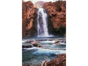FILE - This 1993 file photo shows Havasu Falls in the Grand Canyon, Ariz. The Arizona canyon famous for its blue-green waterfalls is reopening Saturday, Sept. 1, 2018, weeks after flooding closed it to tourism. (The Arizona Republic via AP, File)