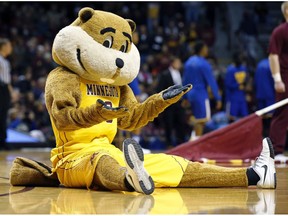 FILE - In this Nov. 13, 2015 file photo, Minnesota mascot Goldy Gopher gestures to the crowd during the first half of an NCAA college basketball game against UMKC in Minneapolis. The university is among several that aggressively protects it's trademark. It ordered a British liquor company to rename its Goldy Gin brand and abandon its trademark applications for the name, saying that consumers would think its products were licensed by the university.