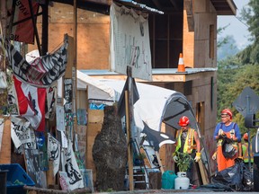 Burnaby RCMP and city of Burnaby officials dismantle Camp Cloud near the entrance of the Kinder Morgan Trans Mountain pipeline facility in Burnaby, B.C., on Thursday August 16, 2018.