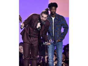 Post Malone, left, and 21 Savage accept the award for song of the year for "Rockstar" at the MTV Video Music Awards at Radio City Music Hall on Monday, Aug. 20, 2018, in New York.