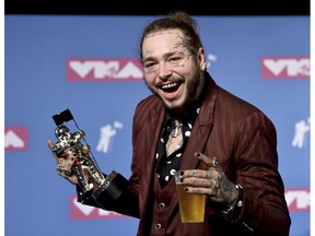 Post Malone poses with the award for song of the year for "Rockstar" in the press room at the MTV Video Music Awards at Radio City Music Hall on Monday, Aug. 20, 2018, in New York.