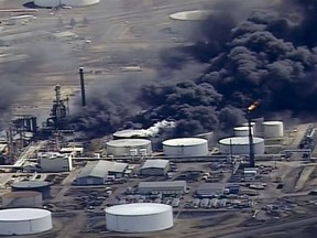 FILE - In this April 26, 2018, file image from video, smoke rises from the Husky Energy oil refinery after an explosion and fire at the plant in Superior, Wis. A federal agency reports the explosion at a Wisconsin refinery sent debris into an asphalt storage tank, triggering a massive fire that forced an evacuation last spring. The U.S. Chemical Safety Board released an update Thursday, Aug. 2, 2018 on the explosion and fire at the refinery in late April. (KSTP-TV via AP, File)