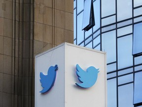 FILE - This Oct. 26, 2016 file photo shows a Twitter sign outside of the company's headquarters in San Francisco. Some political die-hards are getting caught up in an expanded effort by Twitter and other social media companies to crack down on nefarious tactics suspected of interfering in the 2016 election. They have been flagged as "bots," or robot-like automated accounts, because they tweet prolifically.