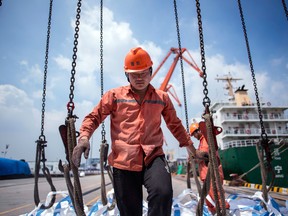 A worker at a port in China. New tariffs on US$200 billion of Chinese imports will force Americans to pay more for items they use throughout their daily lives, say U.S. businesses.