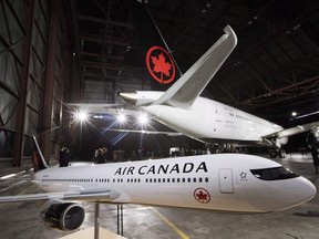 A model airplane is seen in front of the newly revealed Air Canada Boeing 787-8 Dreamliner aircraft at a hangar at the Toronto Pearson International Airport in Mississauga, Ont., Thursday, February 9, 2017.