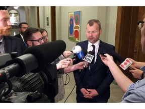 Saskatchewan Energy Minister Dustin Duncan speaks with reporters at the provincial legislature, in Regina, Sask., on Thursday, November 17, 2016. The Saskatchewan government is doubling down on its climate change strategy and continues to defy Ottawa's demand it put a price on carbon emissions. Environment Minister Dustin Duncan says the province is expanding emission limits based on production for facilities like potash mines and pulp mills.