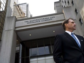 A man is seen outside the Manulife Financial head office in Toronto after their Annual General Meeting in 2012.