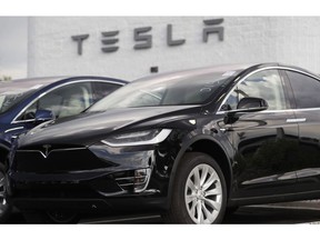 Electric car maker Tesla Motors Canada ULC is suing the Ontario government, claiming it has been treated unfairly in the government's decision to cancel an electric vehicle rebate. A 2018 Model X sits on display outside a Tesla showroom in Littleton, Colo., on July 8, 2018.