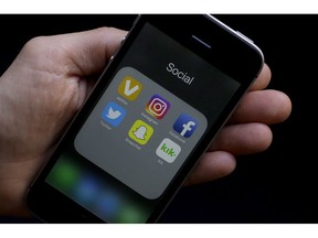 Social media app icons are shown on a smartphone in San Francisco, June 16, 2017. The back-to-school period is one of the busiest times of the year for Canadian telecom companies, resulting in a barrage of special promotions - which can be both a blessing and a curse for budget-minded students.