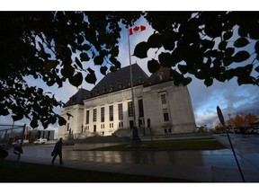 A pedestrian walks past the Supreme Court of Canada in Ottawa, Oct. 18, 2013. The Supreme Court of Canada will announce this morning if it will hear an appeal from the Toronto Real Estate Board that would keep TREB's members from publishing home sales data on their password-protected sites.