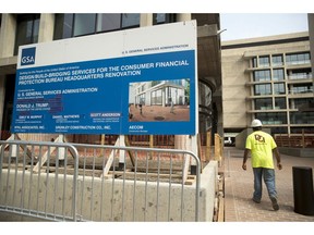 A sign stands at the construction site for the Consumer Financial Protection Bureau's new headquarters in Washington, Monday, Aug. 27, 2018. Seth Frotman, the nation's top government official overseeing the $1.5 trillion student loan market resigned on Monday, citing what he says is the White House's open hostility toward protecting student loan borrowers. Frotman is the latest high-level departure from the CFPB since Mick Mulvaney took over in late November.