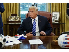 President Donald Trump listens to a question during a meeting with FIFA president Gianni Infantino and United States Soccer Federation president Carlos Cordeiro in the Oval Office of the White House, Tuesday, Aug. 28, 2018, in Washington.