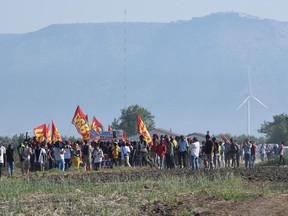 African migrant workers stage a march to protest against their work conditions, following the death of 16 of their colleagues in two separate road accidents, near Foggia, Italy, Wednesday, Aug. 8, 2018. Several hundred of tomatoes fruit pickers marched from the shanty town of San Severo to Foggia as an Italian labor union called for a national strike to raise awareness over the extremely poor working and housing conditions of immigrant farm workers in Italy.