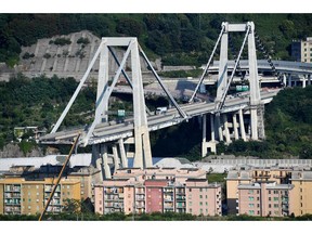A view of the partially collapsed Morandi highway bridge, in Genoa, Italy, Sunday, Aug. 19, 2018. The unofficial death toll in Tuesday's collapse rose to 43 Saturday.