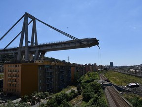 A view of the evacuated houses built under the remains part of the collapsed Morandi highway bridge, in Genoa, northern Italy, Wednesday, Aug. 15, 2018. A bridge on a main highway linking Italy with France collapsed in the Italian port city of Genoa during a sudden, violent storm, sending vehicles plunging 90 meters (nearly 300 feet) into a heap of rubble below.