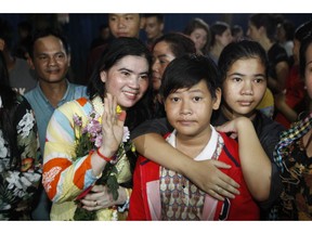 A prominent leader of Cambodia's land rights activist Tep Vanny, second from left, gestures upon the arrival at her home in Boeung Kak, in Phnom Penh, Cambodia, Monday, Aug. 20, 2018. A prominent leader of Cambodia's land rights movement and three women activists who were sent to prison with her were freed Monday under a royal pardon.