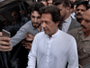 A Pakistani takes a selfie with Imran Khan, centre, head of the Pakistan Tehreek-e-Insaf party, as he leaves a party meeting in Islamabad, the Pakistani capital. The party won the most parliament seats in July’s general elections and is expected to form a governing coalition later this month.