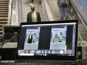 FILE - In this Tuesday, Feb. 27, 2018 file photo ThruVision suicide vest-detection technology reveals a suspicious object on a man, at left, during a Transportation Security Administration demonstration in New York's Penn Station. Los Angeles is poised to have the first mass transit system in the U.S. with body scanners that screen passengers for weapons and explosives. Officials from the Los Angeles County Metropolitan Transportation Authority and the Transportation Security Administration have scheduled a Tuesday, Aug. 14, 2018, news conference. The TSA has been working on the experimental devices, known as standoff explosive detection units, since 2004 with transit agencies. They hadn't been deployed permanently at any transit hub.