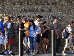 People line up at the California Department of Motor Vehicles prior to opening in the Van Nuys section of Los Angeles on Tuesday, Aug. 7, 2018. California lawmakers are seeking answers from the DMV about long wait times, prompted by their own experiences at agency offices in their districts and complaints from their constituents. Lawmakers plan to discuss the problem at hearings on Tuesday at the Capitol.