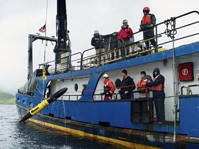In this July 14, 2018 photo provided by Project Recover, scientists deploy one of four Remote Environmental Monitoring Units (REMUS) as they search for the stern of the destroyer USS Abner Read in the waters off Kiska Island, Alaska. The Abner Read hit a mine left by the Japanese after they abandoned Kiska Island in Alaska's Aleutian Islands in 1943, ripping the stern off. But the ship never sank and was refitted and returned to duty. Now, 75 years after the ship's stern broke off, it has been located off Kiska by a team of scientists funded by the U.S. government.
