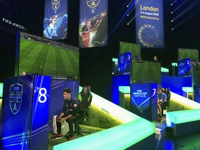 In this photo taken on Thursday, Aug. 2, 2018, competitors take part in the eWorld Cup grand final in London. Three weeks after the World Cup finished in Russia, the finals of the e-sports version are taking place in London, with gamers being tested for performance-enhancing substances for the first time by FIFA. It's a sign of the increasing professionalization of the gaming version of the World Cup, with the winner collecting $250,000.