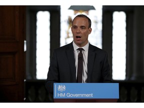 Britain's Secretary of State for Exiting the European Union, Dominic Raab gestures during his speech outlining the government's plans for a no-deal Brexit in London, Thursday, Aug. 23, 2018. The British government says it will unilaterally accept some European Union rules and give EU financial services firms continued access to the U.K. market in order to maintain stability if the country crashes out of the bloc without a deal.