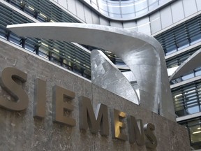FILE - In this Thursday, Nov. 9, 2017 file photo, the logo of German industrial conglomerate Siemens in front of the headquarters in Munich, Germany. German industrial conglomerate Siemens reports its third quarter earnings on Thursday, Aug. 2, 2018.