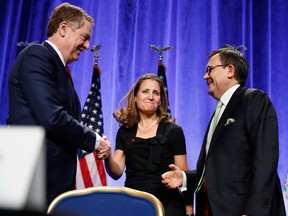 U.S. Trade Representative Robert Lighthizer, left, shakes hands with Canadian Foreign Affairs Minister Chrystia Freeland, accompanied by Mexico's Secretary of Economy Ildefonso Guajardo Villarreal, after they spoke at a news conference, Wednesday, Aug. 16, 2017, at the start of NAFTA renegotiations in Washington.