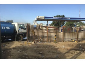 FILE - In this Sunday Oct. 1, 2017 file photo, a truck waits outside a closed petrol station of the Nile Petroleum Corporation in Juba, South Sudan. South Sudan says it will resume oil production in a key region in September 2018 to make up for more than $4 billion of revenue lost during years of fighting.