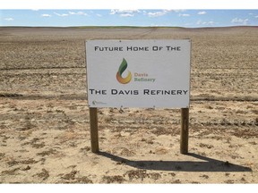 FILE - This July 19, 2018, file photo, shows a sign on property, near southwest Belfield, N.D, for the future home of the Davis Refinery near Theodore Roosevelt National Park. Opponents of an oil refinery planned near Theodore Roosevelt National Park in North Dakota are imploring state regulators to give them a chance to explore whether the developer is being truthful about the project's size. Meridian Energy Group maintains it doesn't need a state siting permit because the $800 million Davis Refinery won't have a big enough capacity.