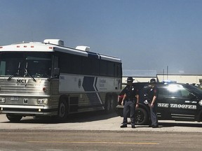 An ICE bus pulls out of a tomato plant in O'Neill, Neb., after an immigration raid at the plant Wednesday, Aug. 8, 2018. A large federal law enforcement operation conducted Wednesday targeted businesses in Nebraska and Minnesota that officials say knowingly hired - and mistreated - immigrants who are in the U.S. illegally.