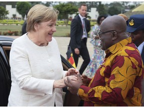 German Chancellor Angela Merkel, left, is welcomed by Ghana's President, Nana Akufo-Addo, right, at the Presidential palace in Accra, Ghana, Thursday, Aug 30, 2018. Merkel has arrived in Ghana during a three-nation West Africa visit aimed at boosting investment in a region that is a major source of migrants heading towards Europe.