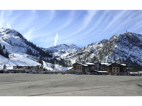 FILE - This Dec. 16, 2013 file photo, shows the expansive parking lot at the base village at Squaw Valley in Olympic Valley, Calif. Environmentalists have lost their latest legal bid to block a major redevelopment project at a Lake Tahoe-area ski resort that hosted the 1960 Winter Olympics. Placer County Superior Court Judge Michael W. Jones on Aug. 13, 2018, rejected Sierra Watch's claims that the expansion of the Village at Squaw Valley would violate the California Environmental Quality Act.