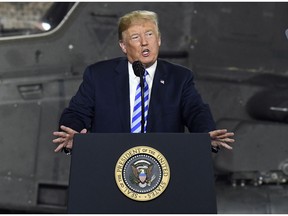 FILE - In this Aug. 13, 2018 file photo, President Donald Trump speaks before signing a $716 billion defense policy bill named for Sen. John McCain  in Fort Drum, N.Y.  Trump says he's asking federal regulators to look into the effectiveness of the quarterly financial reports that publicly traded companies are required to file.  In a tweet early Friday, Aug. 17, Trump said that after speaking with "some of the world's top business leaders," he's asked the U.S. Securities and Exchange Commission to determine whether shifting to a six-month reporting regimen would make more sense.