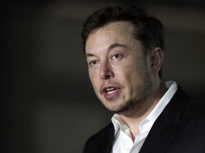 FILE - In this June 14, 2018, file photo, Tesla CEO Elon Musk speaks at a news conference in Chicago.  Tesla is forming a special committee to evaluate  Musk's plan to take the company private. The electric car maker said Tuesday, Aug. 14, 2018  that the committee will include three independent directors. The committee has yet to receive a formal proposal from Musk on a going private transaction.