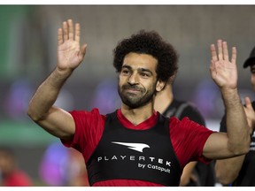 FILE - In this June 9, 2018, file photo, Egyptian national team soccer player and Liverpool's star striker Mohamed Salah smiles as he greets fans during the final training of the national team at Cairo Stadium in Cairo, Egypt. Salah has revived a months-long dispute with soccer authorities in his native Egypt, accusing them of ignoring his complaints about their unauthorized use of his image.