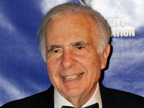 FILE - In this March 16, 2010, file photo, financier Carl Icahn poses for photos upon arriving for the annual New York City Police Foundation Gala in New York. Icahn is urging Cigna shareholders to vote against the health insurer's attempted multi-billion dollar takeover of Express Scripts. In a letter Tuesday, Aug. 7, 2018, Icahn warned that Express Scripts, a pharmacy benefit manager, faces intense competition from Amazon, regulatory risks and could lose the business of other health insurers that won't want to deal with a company owned by a rival.