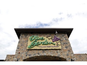 FILE - This June 27, 2016, file photo, shows an Olive Garden restaurant in Methuen, Mass. Olive Garden customers who can't get enough pasta have a chance to enjoy unlimited servings for a year. The restaurant chain is offering its first annual pasta pass as part of its never ending pasta bowl promotion. The pass is available to 1,000 customers who pay $300.