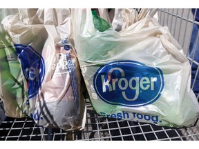 FILE - This June 15, 2017, file photo shows bagged purchases from the Kroger grocery store in Flowood, Miss. The nation's largest grocery chain will phase out the use of plastic bags in its stores by 2025.