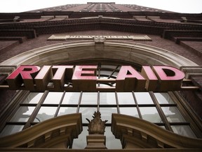 FILE- This Oct. 21, 2016, file photo shows a Rite Aid location in Philadelphia. Rite Aid chopped its full-year profit forecast three days before its shareholders vote on a bid by the grocer Albertsons Companies to buy the drugstore chain. Rite Aid said Monday, Aug. 6, 2018, that generic drug pricing isn't shaping up like it expected in April when it made a fiscal 2019 forecast it reaffirmed in June.