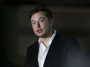 FILE- In this June 14, 2018, file photo Tesla CEO and founder of the Boring Company Elon Musk speaks at a news conference in Chicago. Musk says he is considering taking the electric car maker private. Tesla's stock spiked Tuesday, Aug. 7, after Musk made the abrupt announcement in a terse tweet.