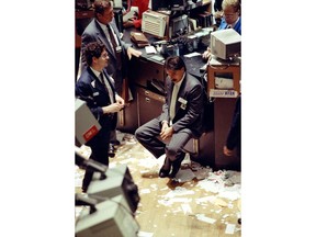 FILE- In this July 17, 1990, file photo a trader relaxes after the closing bell in the New York Stock Exchange. In 1990, the S&P 500 declined 19.92 percent from July 16 until Oct. 11.