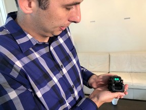 In this Monday, July 30, 2018, photo, Anki Inc. CEO Boris Sofman holds Vector, the company's new home robot, in New York. The wheeled robot is designed as a successor to the San Francisco company's toy robot, Cozmo, which was introduced in 2016.