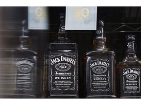 FILE- This July 9, 2018, file photo shows bottles of Jack Daniel's whiskey displayed at Rossi's Deli in San Francisco. Spirits company Brown-Forman Corp. said Wednesday, Aug. 29, that its first-quarter net income rose sharply, fueled by strong overseas sales, but the maker of Jack Daniel's Tennessee Whiskey cautioned that global trade disputes are causing "significant uncertainty."